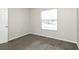 Neutral bedroom with a window letting in natural light and a door at 148 Conch Dr, Kissimmee, FL 34759