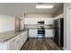 Modern kitchen featuring granite countertops, stainless steel appliances, and white cabinetry at 148 Conch Dr, Kissimmee, FL 34759