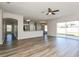 The open-concept living room flows into the kitchen and dining areas, with hardwood floors and large windows at 148 Conch Dr, Kissimmee, FL 34759