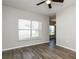 The living room features hardwood floors, a ceiling fan, and natural light from the windows at 148 Conch Dr, Kissimmee, FL 34759
