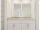 Bright bathroom with granite countertops and dual sinks offers a modern and stylish space at 16390 Bird Of Paradise Ave, Clermont, FL 34714