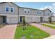 Attractive townhomes boast well-maintained landscaping and brick driveways for enhanced curb appeal at 16390 Bird Of Paradise Ave, Clermont, FL 34714