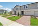 Attractive townhomes boast well-maintained landscaping and brick driveways for enhanced curb appeal at 16390 Bird Of Paradise Ave, Clermont, FL 34714