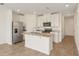 Bright kitchen with stainless steel appliances, granite countertops and white cabinets at 16390 Bird Of Paradise Ave, Clermont, FL 34714