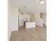 Open-concept living room flows into a kitchen with stainless steel appliances and center island at 16390 Bird Of Paradise Ave, Clermont, FL 34714