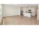 Open-concept living room flows into a kitchen with stainless steel appliances and center island at 16390 Bird Of Paradise Ave, Clermont, FL 34714