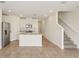 Open-concept living room flows into a kitchen with stainless steel appliances and center island at 16390 Bird Of Paradise Ave, Clermont, FL 34714