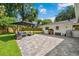 Spacious backyard features a stone patio, outdoor seating, a basketball hoop, and a playhouse by the house at 2114 Geigel Ct, Orlando, FL 32806