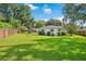 Expansive backyard with lush green lawn, privacy fence, and a patio area, ideal for outdoor entertaining and leisure at 2114 Geigel Ct, Orlando, FL 32806