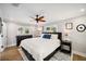 A serene bedroom with hardwood floors, a ceiling fan, and natural light from two windows at 2114 Geigel Ct, Orlando, FL 32806