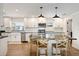 Modern kitchen with white cabinets, subway tile backsplash, a farmhouse sink, and a large island with seating at 2114 Geigel Ct, Orlando, FL 32806