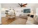Open-concept living space blending kitchen and living room areas, featuring modern decor and wood floors at 2114 Geigel Ct, Orlando, FL 32806