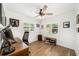 Well-lit office space featuring hardwood floors, white walls, a ceiling fan, and natural light from windows at 2114 Geigel Ct, Orlando, FL 32806