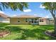 A well-maintained backyard with green grass and the back of the property at 21144 Royal St Georges Ln, Leesburg, FL 34748