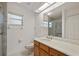 Bathroom featuring a vanity, sink, toilet, walk-in shower, and a large mirror at 21144 Royal St Georges Ln, Leesburg, FL 34748