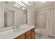 Bathroom featuring a vanity with quartz counters, a bathtub, and a skylight at 21144 Royal St Georges Ln, Leesburg, FL 34748
