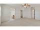 Bedroom with light colored walls, carpeted floors, and access to the bathroom and walk in closet at 21144 Royal St Georges Ln, Leesburg, FL 34748