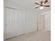 This bedroom has carpet, a ceiling fan, closet, and an ensuite at 21144 Royal St Georges Ln, Leesburg, FL 34748