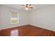 Bedroom with hardwood floors, light colored walls, and a window with blinds at 21144 Royal St Georges Ln, Leesburg, FL 34748