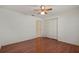 This bedroom has wood flooring, ceiling fan, and a closet at 21144 Royal St Georges Ln, Leesburg, FL 34748