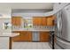 A spacious kitchen with stainless steel appliances, wood cabinets, and sleek countertops at 21144 Royal St Georges Ln, Leesburg, FL 34748