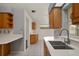 The kitchen features wood cabinets, sleek countertops, and views through the window to the outdoors at 21144 Royal St Georges Ln, Leesburg, FL 34748