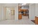 This open-concept kitchen features stainless steel appliances, sleek countertops, and tile flooring at 21144 Royal St Georges Ln, Leesburg, FL 34748