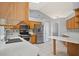 A modern kitchen with stainless steel appliances, light countertops, and ample wood cabinetry at 21144 Royal St Georges Ln, Leesburg, FL 34748
