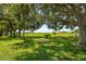 A beautiful lot is framed with mature trees and lush green grass, ready for your dream home at 21144 Royal St Georges Ln, Leesburg, FL 34748