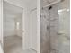 Walk-in shower with grey tile, a glass door, and silver hardware at 21144 Royal St Georges Ln, Leesburg, FL 34748