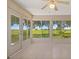 Tiled sunroom with expansive windows and a view of the property at 21144 Royal St Georges Ln, Leesburg, FL 34748