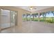 Sunroom with tile floors, large windows, and a sliding door to another room at 21144 Royal St Georges Ln, Leesburg, FL 34748