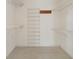 Walk-in closet with wire shelving and a wooden rack with hooks at 21144 Royal St Georges Ln, Leesburg, FL 34748