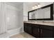 Spacious bathroom with double sink vanity, framed mirror, and a shower-tub combination at 2280 San Vital Dr # 101, Kissimmee, FL 34741