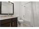Bright bathroom featuring a granite vanity, large mirror, and a shower over a tub at 2280 San Vital Dr # 101, Kissimmee, FL 34741