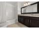 Well-lit bathroom with a double vanity, shower and tub combination, and modern fixtures at 2280 San Vital Dr # 101, Kissimmee, FL 34741