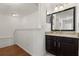 Upstairs half-bathroom with dark wood vanity, granite countertop, and framed mirror at 2280 San Vital Dr # 101, Kissimmee, FL 34741