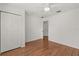 Spacious bedroom with wood floors, ceiling fan, and large closet at 2280 San Vital Dr # 101, Kissimmee, FL 34741