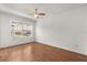 Bright bedroom with ceiling fan, wood floors, and a window view at 2280 San Vital Dr # 101, Kissimmee, FL 34741