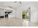 Open-concept living space with tile flooring and sliding glass doors to the patio at 2280 San Vital Dr # 101, Kissimmee, FL 34741
