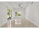 Bright empty living room with tile floors, ceiling fan, and sliding glass door at 2280 San Vital Dr # 101, Kissimmee, FL 34741
