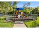 The community playground features colorful equipment and fencing for safety at 2280 San Vital Dr # 101, Kissimmee, FL 34741