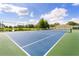 Community tennis court near a scenic pond at 2280 San Vital Dr # 101, Kissimmee, FL 34741