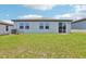 Backyard featuring green grass and covered patio area at 2365 White Tail St, Davenport, FL 33837