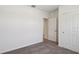 Bedroom features neutral carpet and white doors leading to closet and hallway at 2365 White Tail St, Davenport, FL 33837