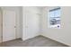 Bedroom features neutral carpet, white doors, and natural light from window at 2365 White Tail St, Davenport, FL 33837