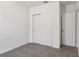 Bedroom with neutral carpet, white walls, and sliding-door closet at 2365 White Tail St, Davenport, FL 33837