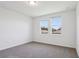 Bedroom with neutral carpet, white walls, and window overlooking rooftop at 2365 White Tail St, Davenport, FL 33837