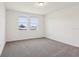 Bedroom with neutral carpet, white walls, and window overlooking rooftop at 2365 White Tail St, Davenport, FL 33837
