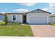 Charming single-story home with a well-manicured lawn and a brick driveway, offering great curb appeal at 2365 White Tail St, Davenport, FL 33837